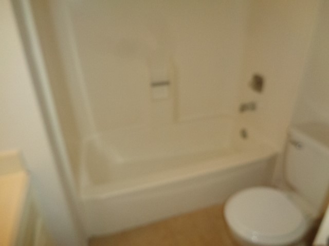 9530 Magnolia Ridge Drive Houston, TX 77070 - Photo 13 of 20 a white toilet sitting next to a white sink