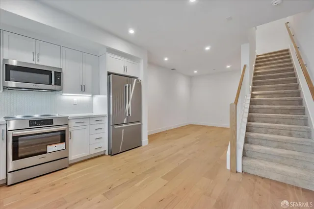 a kitchen with granite countertop stainless steel appliances and wooden cabinets