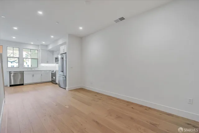a view of a kitchen with a sink and a large window