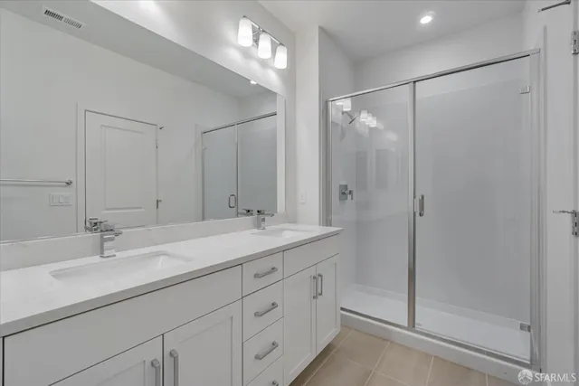 a bathroom with a shower sink and mirror