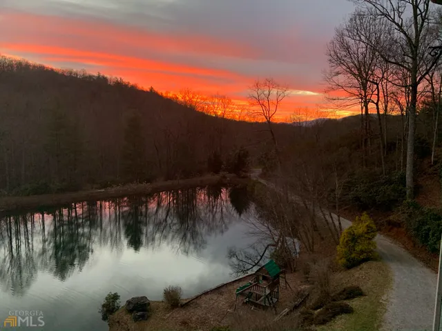 a living room with furniture a piano and a window