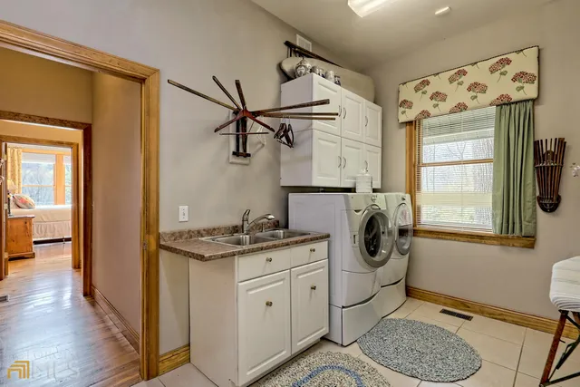 a bathroom with a granite countertop toilet sink and mirror