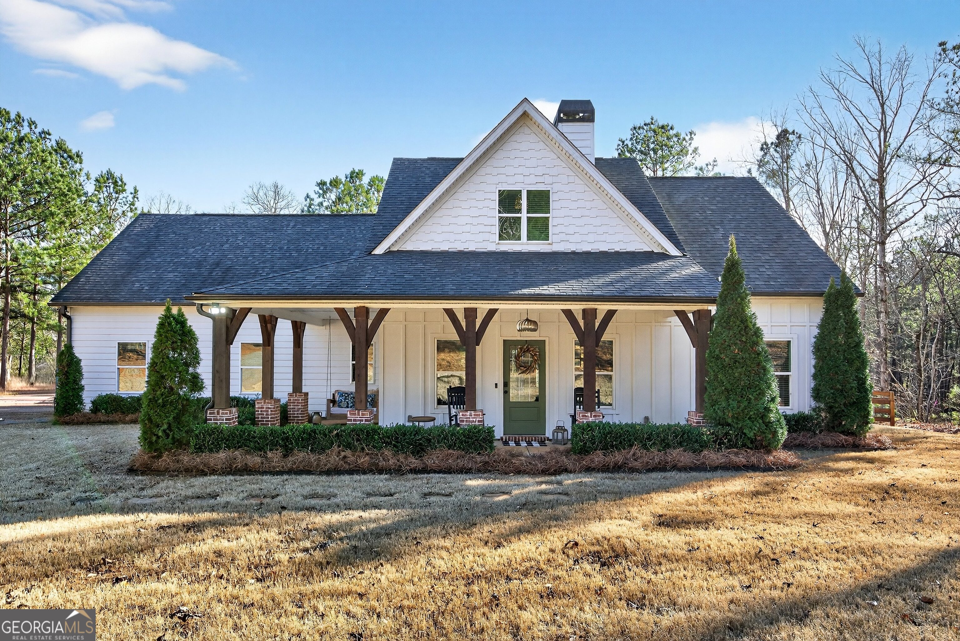 a front view of house with green space