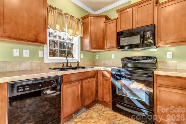 a kitchen with stainless steel appliances a stove a sink and a microwave