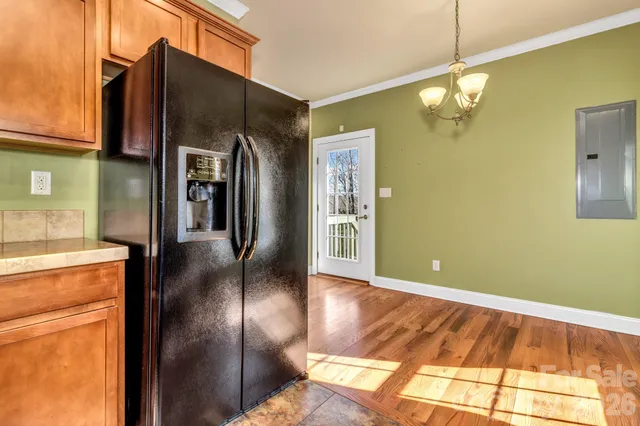 a open kitchen with stainless steel appliances granite countertop a refrigerator and a stove top oven