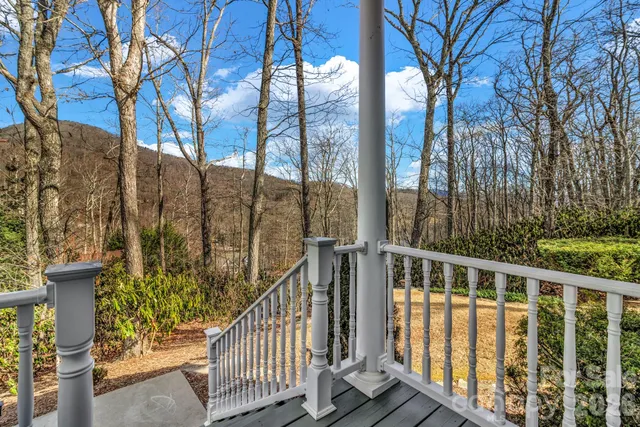 a view of a balcony with wooden fence and floor
