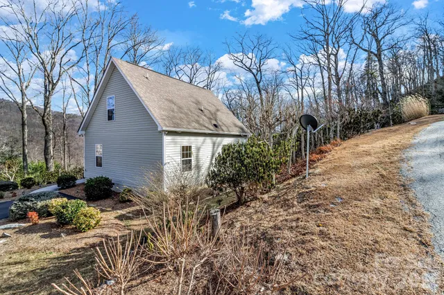 a view of a house with a yard and sitting area