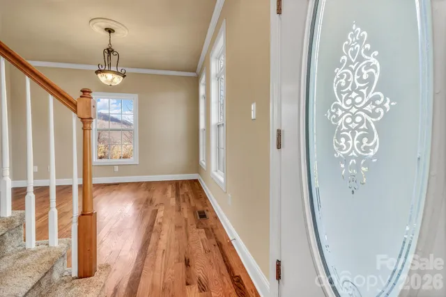 a view of an entryway with wooden floor