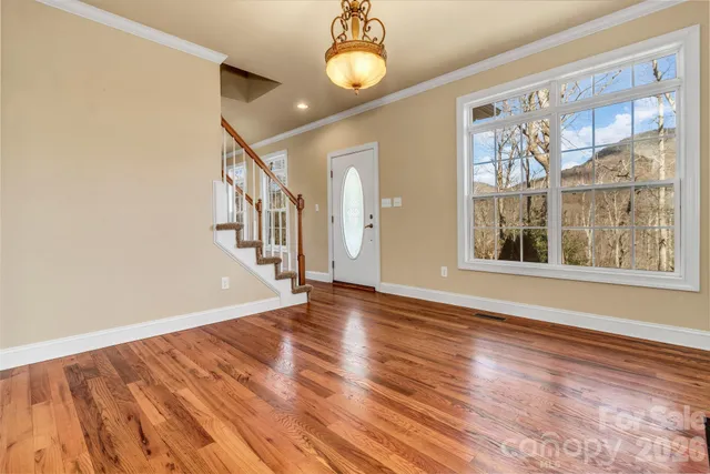 a view of an entryway with wooden floor