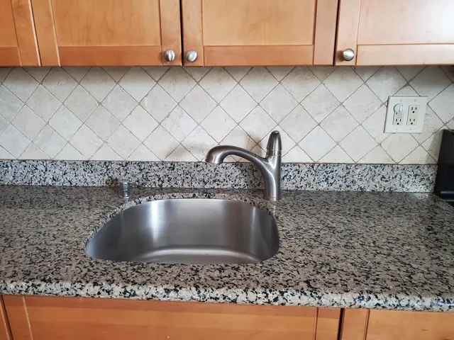 a close view of sink and cabinets