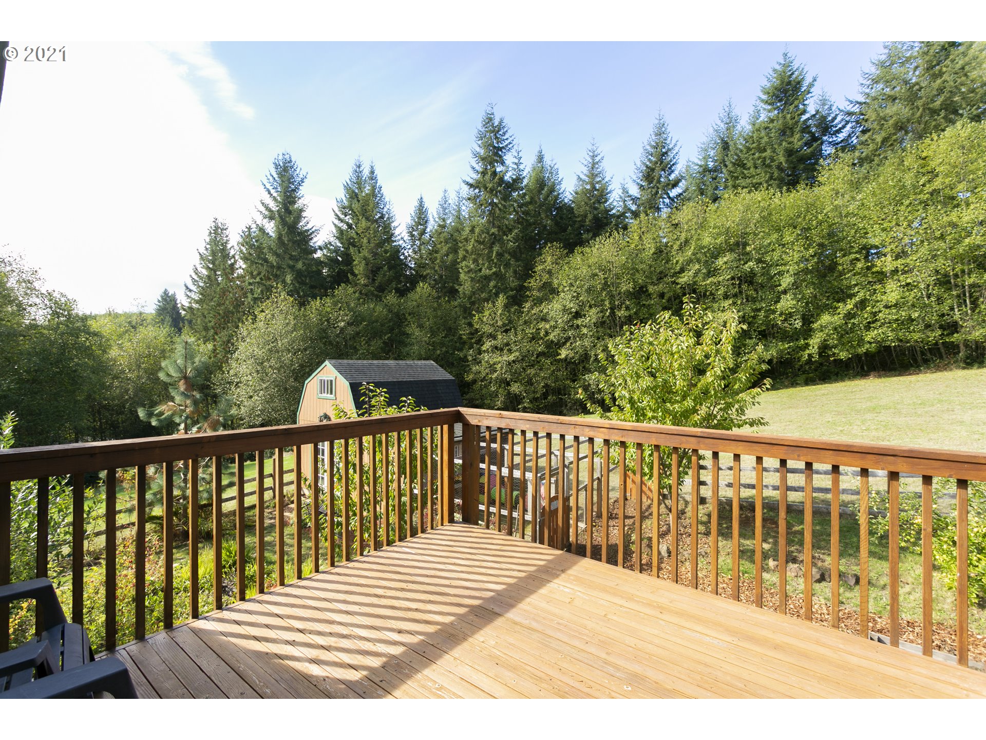 180 Merganser Road Longview, WA 98632 - Photo 23 of 32 a roof deck with wooden floor and fence