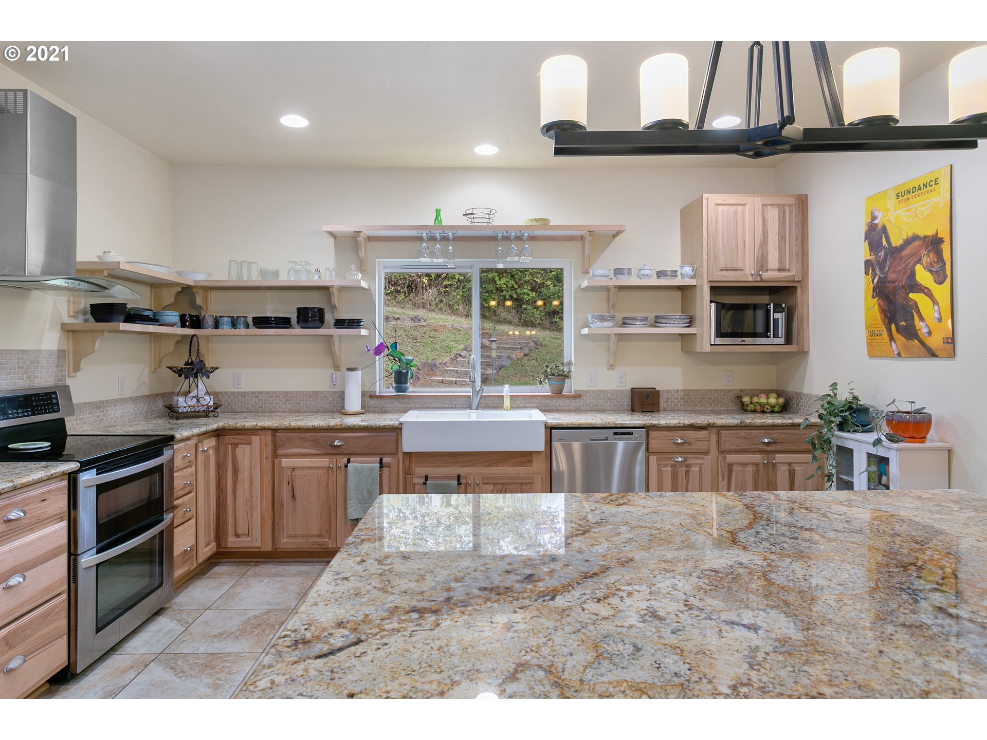 180 Merganser Road Longview, WA 98632 - Photo 6 of 32 a kitchen with stainless steel appliances granite countertop a stove a sink and a microwave