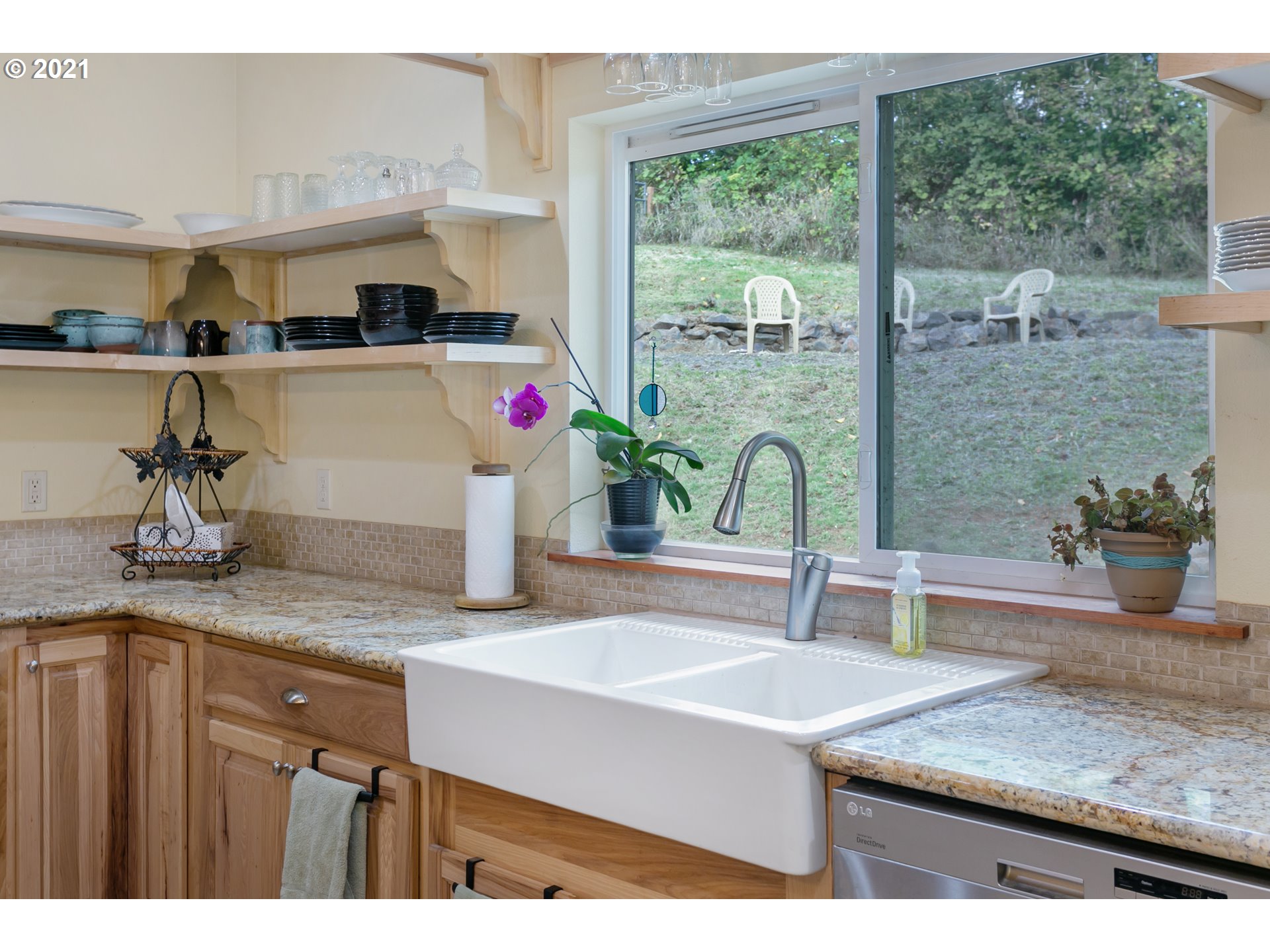 180 Merganser Road Longview, WA 98632 - Photo 7 of 32 a kitchen with a sink and a potted plant