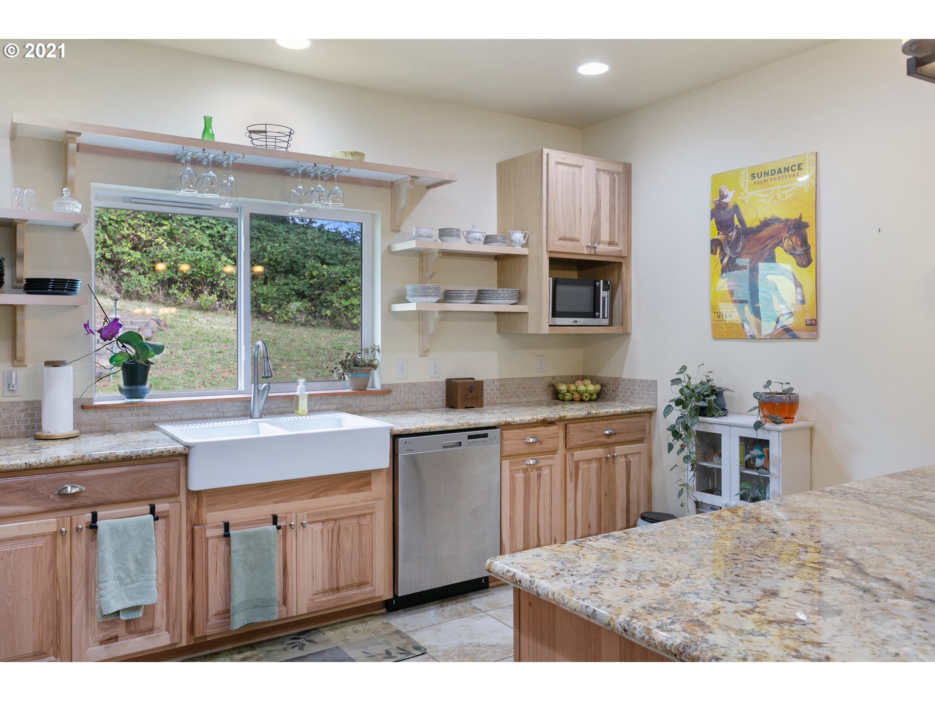 180 Merganser Road Longview, WA 98632 - Photo 8 of 32 a kitchen with stainless steel appliances a stove a sink a microwave a center island and cabinets