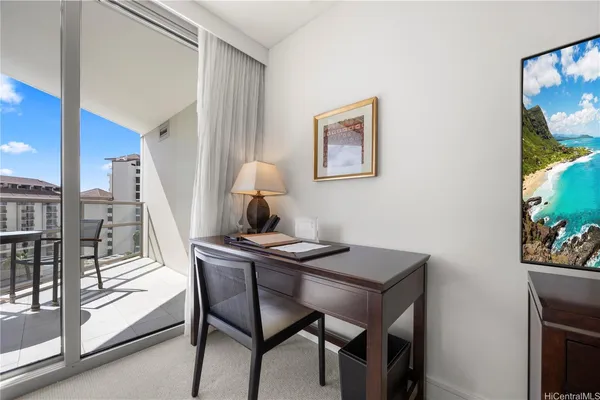 a view of a dining room with furniture and a potted plant