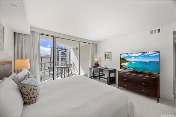 a bedroom with a bed and a flat screen tv