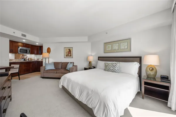 a bedroom with bed and a night stand