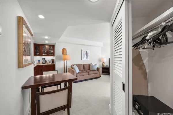 a living room with furniture and a lamp