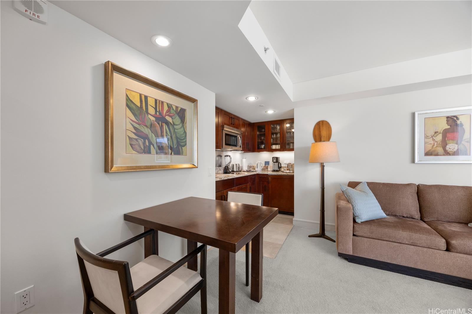 223 Saratoga Road, Unit 1114 Honolulu, HI 96815 - Photo 5 of 23 a living room with furniture and a table