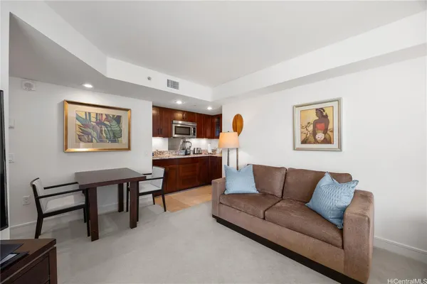 a living room with furniture a rug and a window