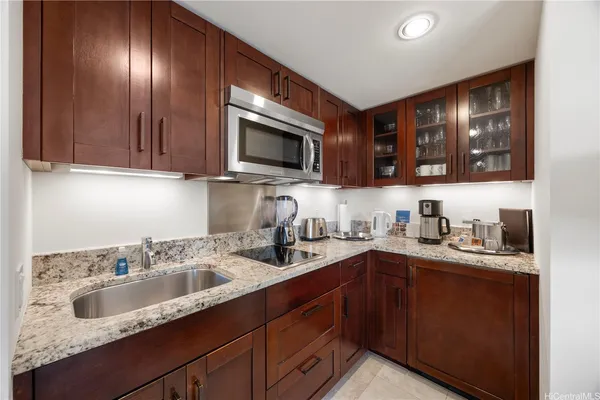 a kitchen with stainless steel appliances granite countertop a sink stove and cabinets