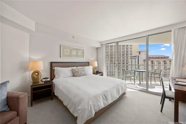 a bedroom with a bed and a large window