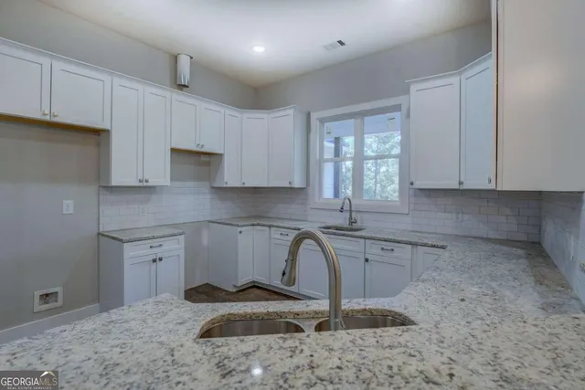 a kitchen with a sink stove and cabinets