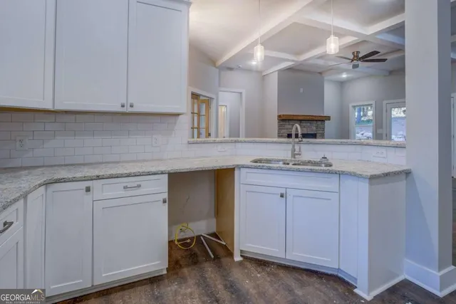 a sink with white cabinets