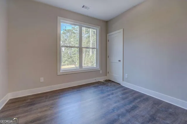 wooden floor with white walls