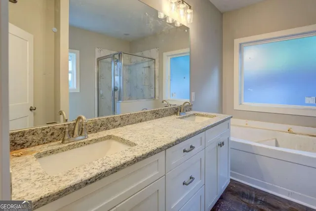 a bathroom with a bathtub a shower and a sink