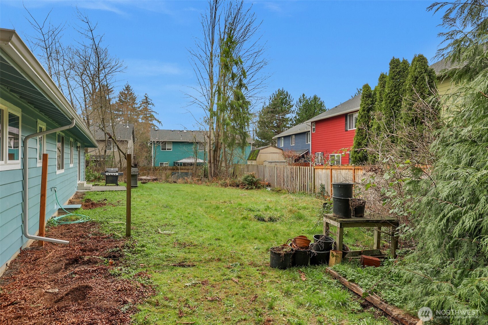 2105 100th Street Southeast Everett, WA 98208 - Photo 27 of 31 a backyard of a house with table and chairs plants