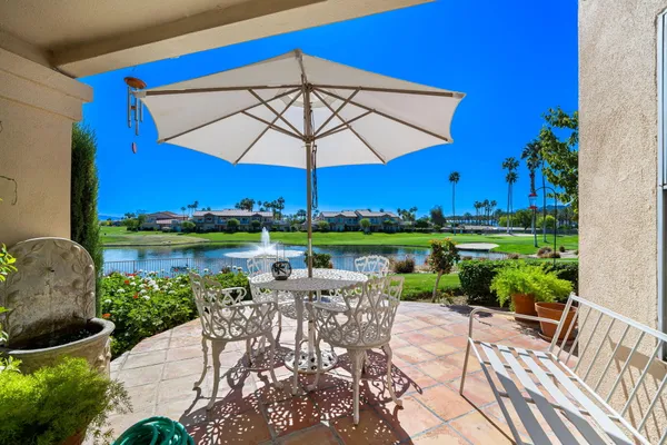 a view of a table and chairs under an umbrella in patio