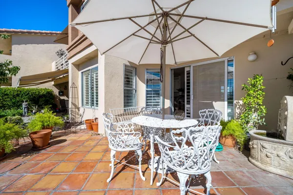a view of a patio with a table and chairs