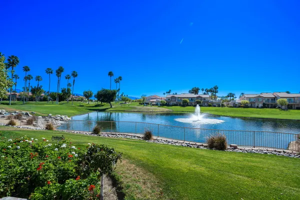 an aerial view of a house with a yard and lake view