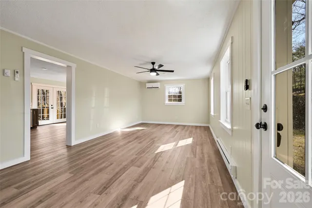 wooden floor in an empty room with a window