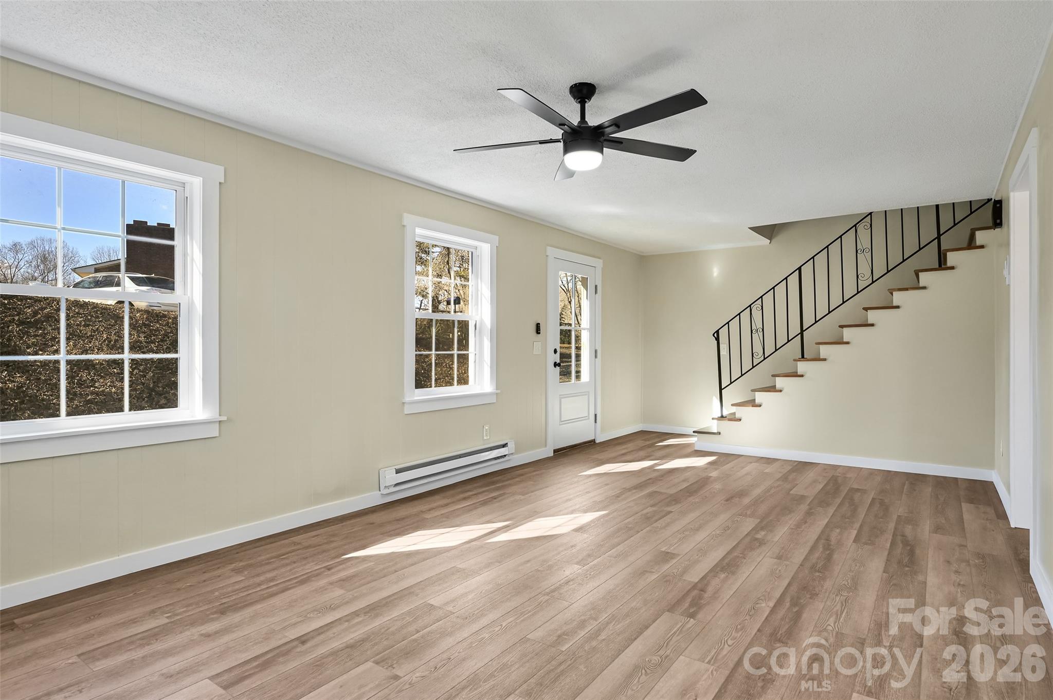 241 Sherrill Lane Canton, NC 28716 - Photo 17 of 39 a view of empty room with wooden floor and fan