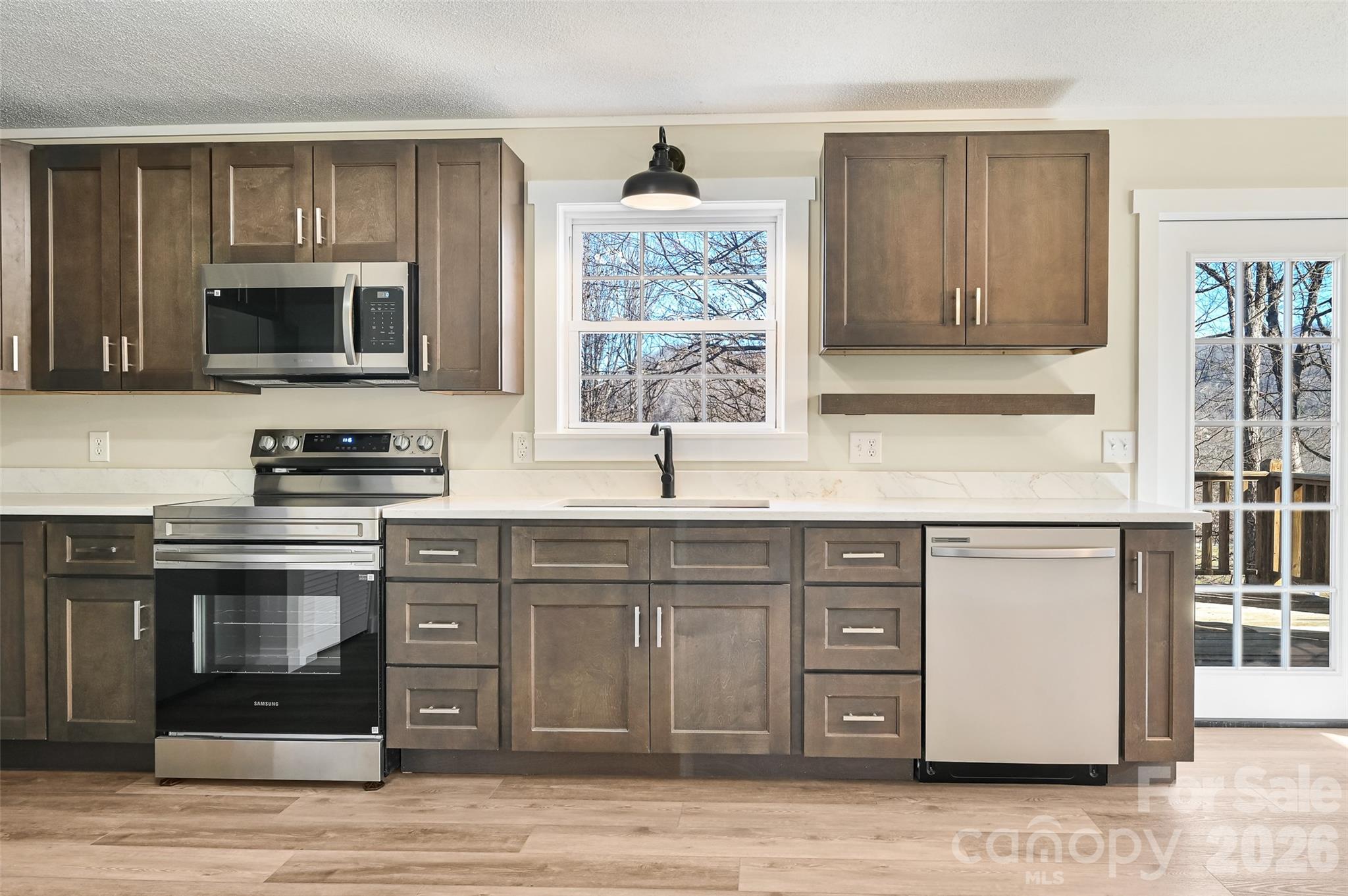 241 Sherrill Lane Canton, NC 28716 - Photo 19 of 39 a kitchen with stainless steel appliances granite countertop a stove a sink and a microwave