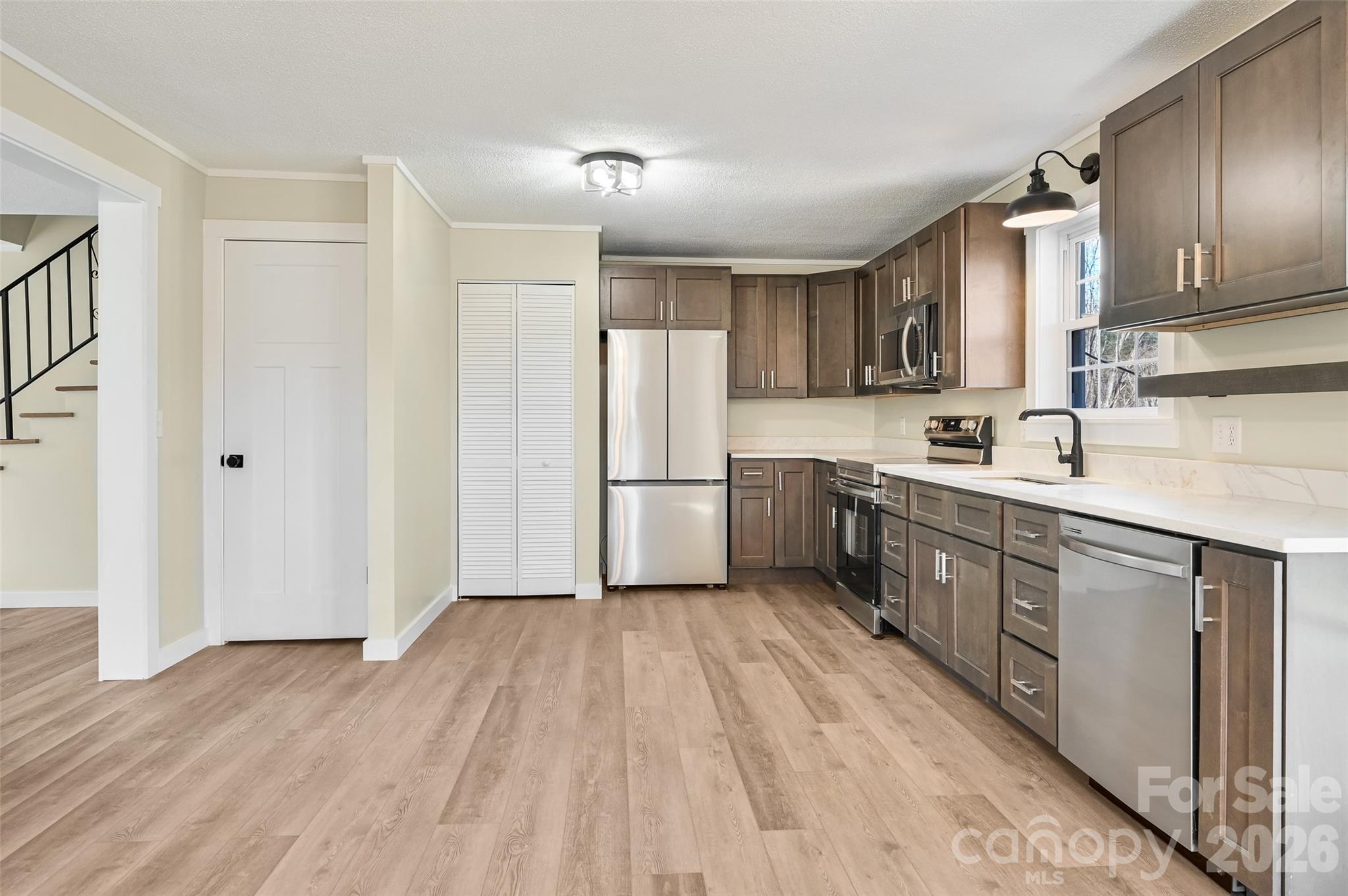 241 Sherrill Lane Canton, NC 28716 - Photo 23 of 39 a kitchen with stainless steel appliances a sink cabinets and wooden floor