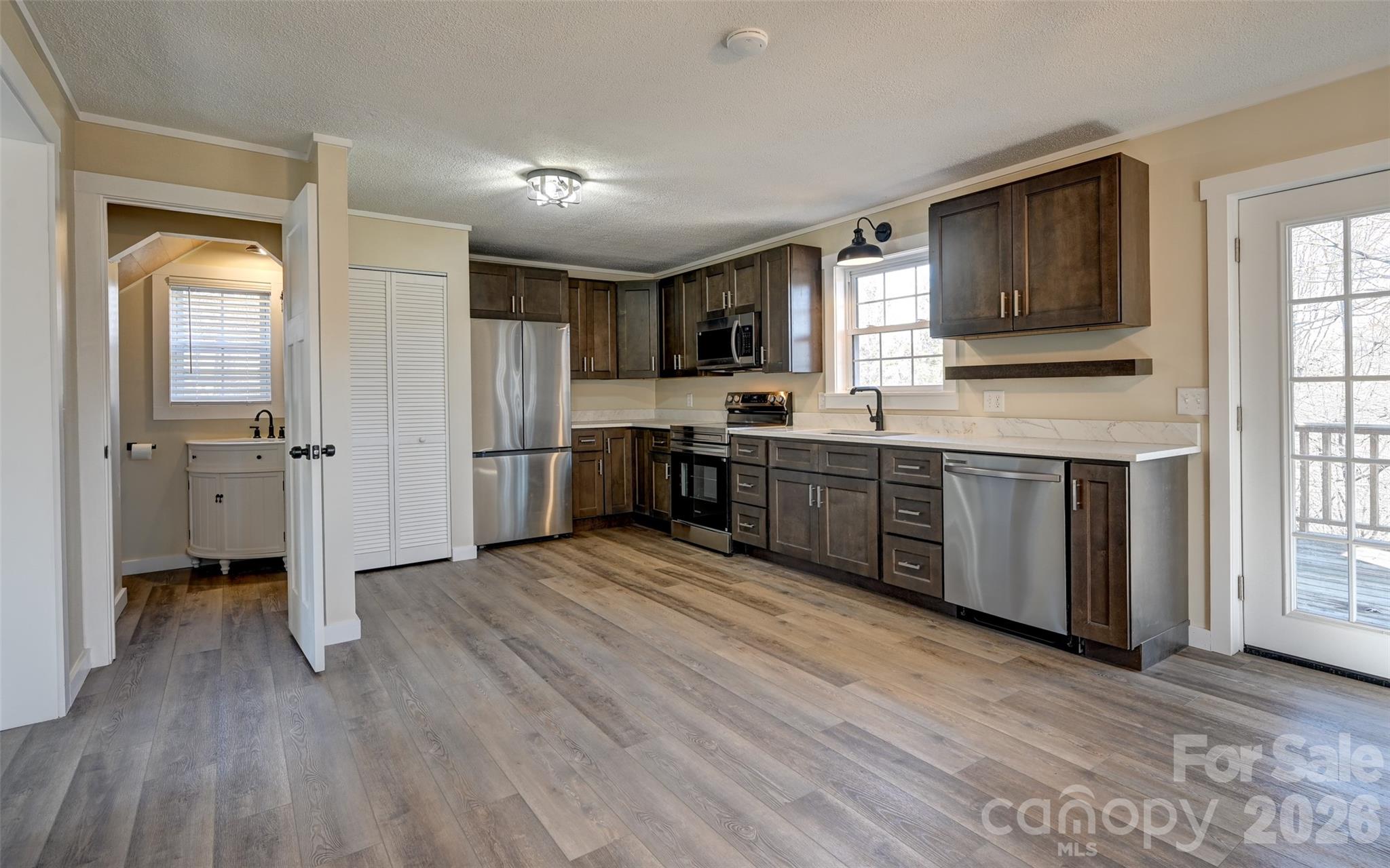 241 Sherrill Lane Canton, NC 28716 - Photo 24 of 39 a view of a kitchen with wooden floor and electronic appliances