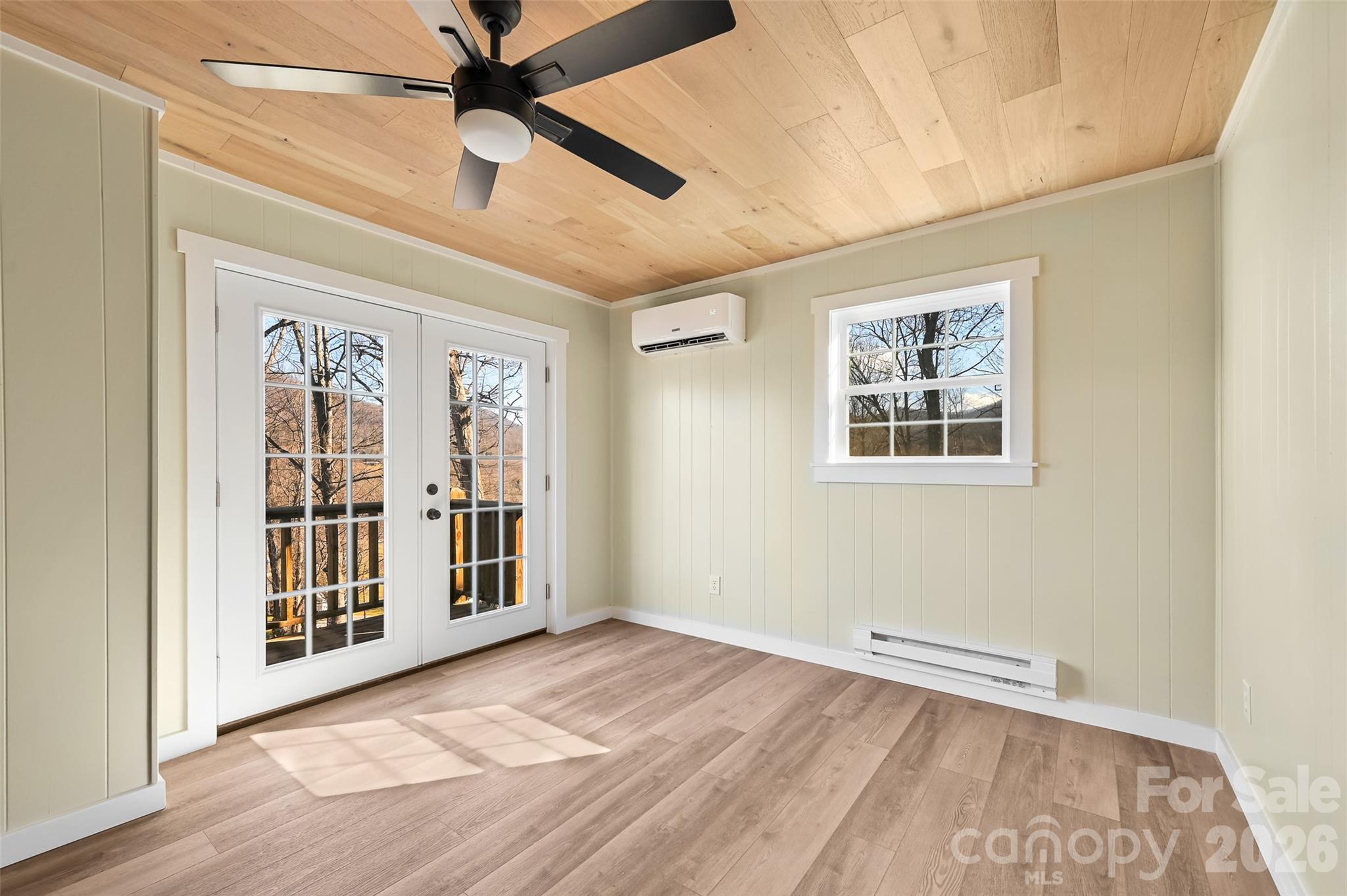 241 Sherrill Lane Canton, NC 28716 - Photo 34 of 39 a view of an empty room with a window and wooden floor