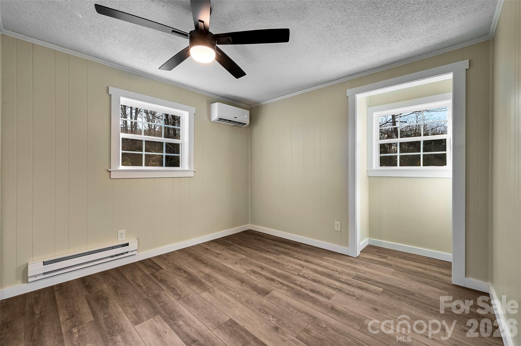 241 Sherrill Lane Canton, NC 28716 - Photo 36 of 39 an empty room with wooden floor cabinet and windows