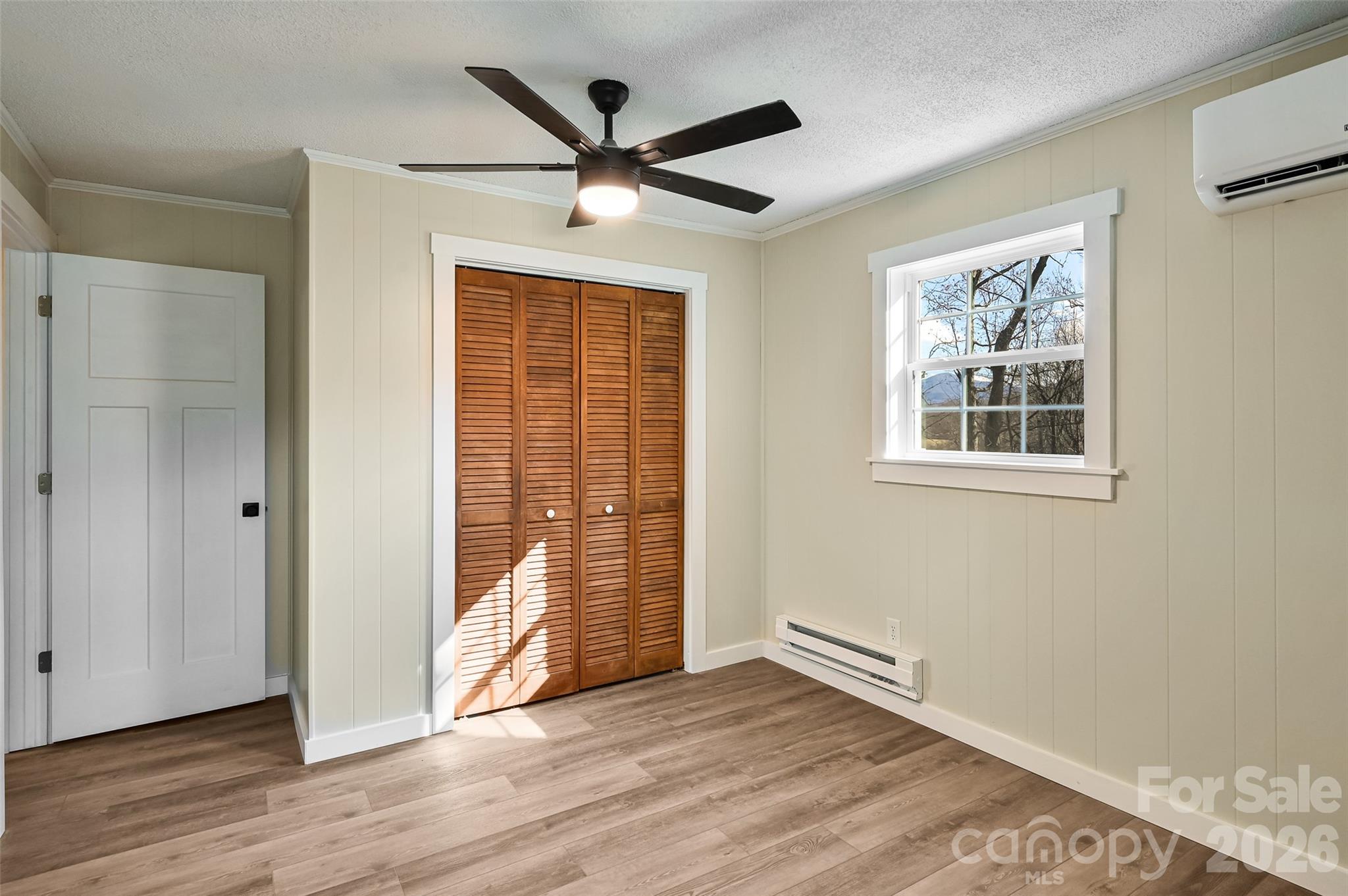 241 Sherrill Lane Canton, NC 28716 - Photo 37 of 39 wooden floor in an empty room with a window