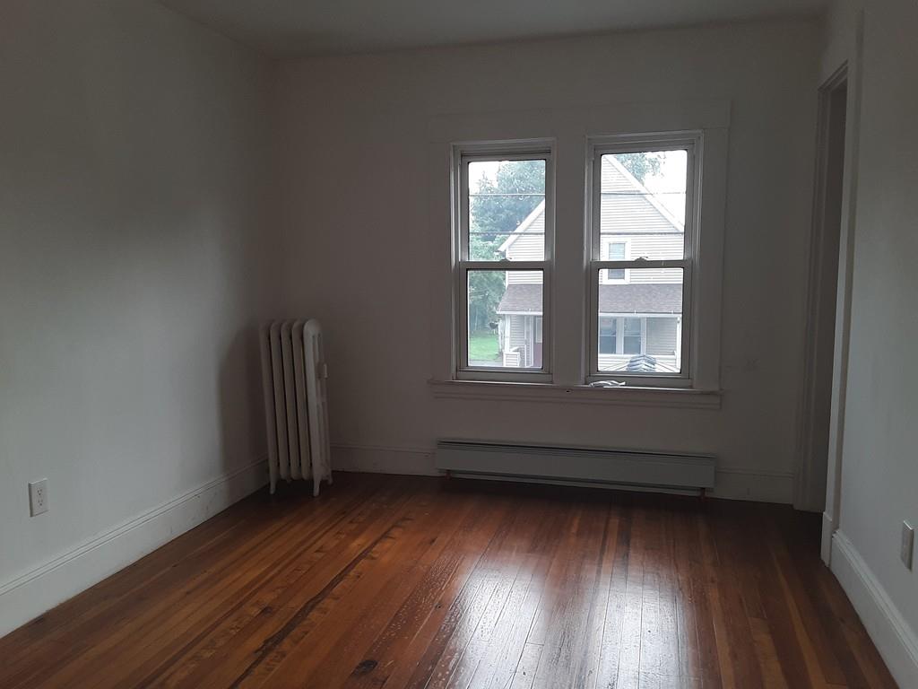 23 Bevier Street Springfield, MA 01107 - Photo 8 of 12 an empty room with wooden floor and windows