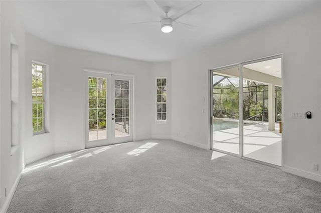 an empty room with windows and view of lake