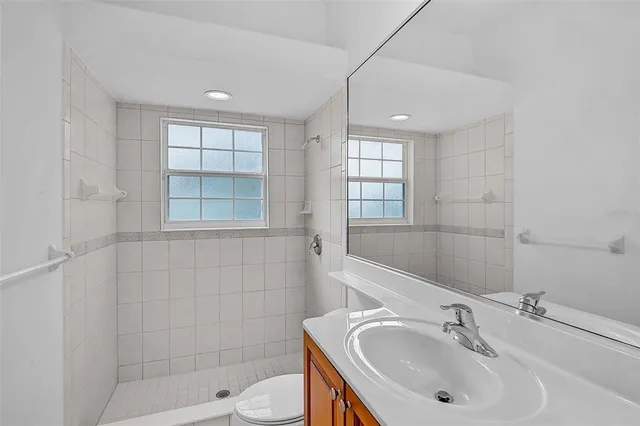 a bathroom with a sink toilet and shower