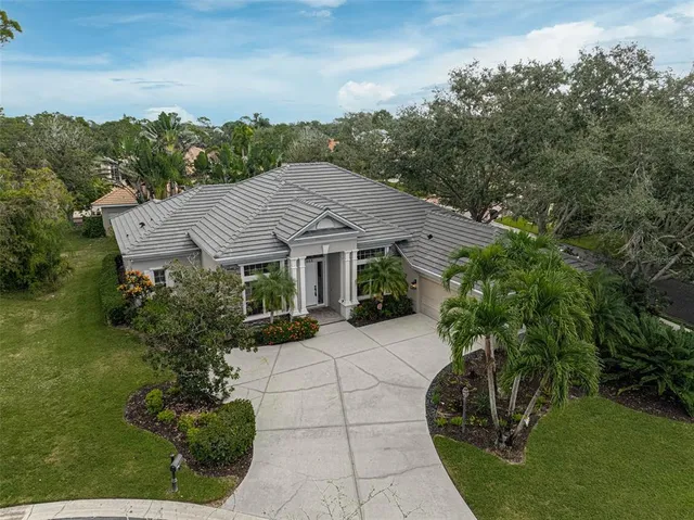 an aerial view of a house with a yard