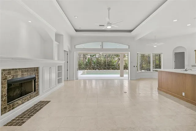 wooden floor fireplace and windows in an empty room