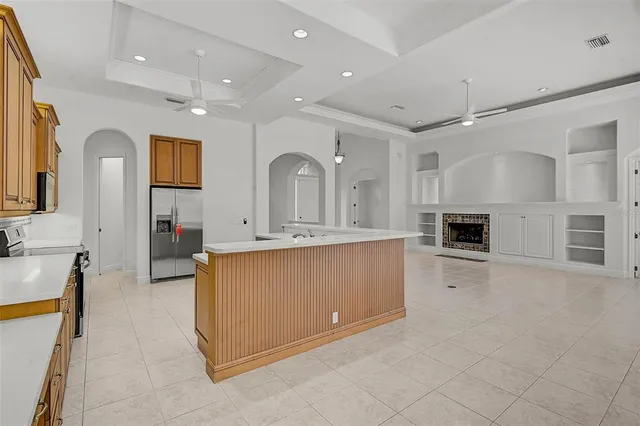 a large white kitchen with cabinets