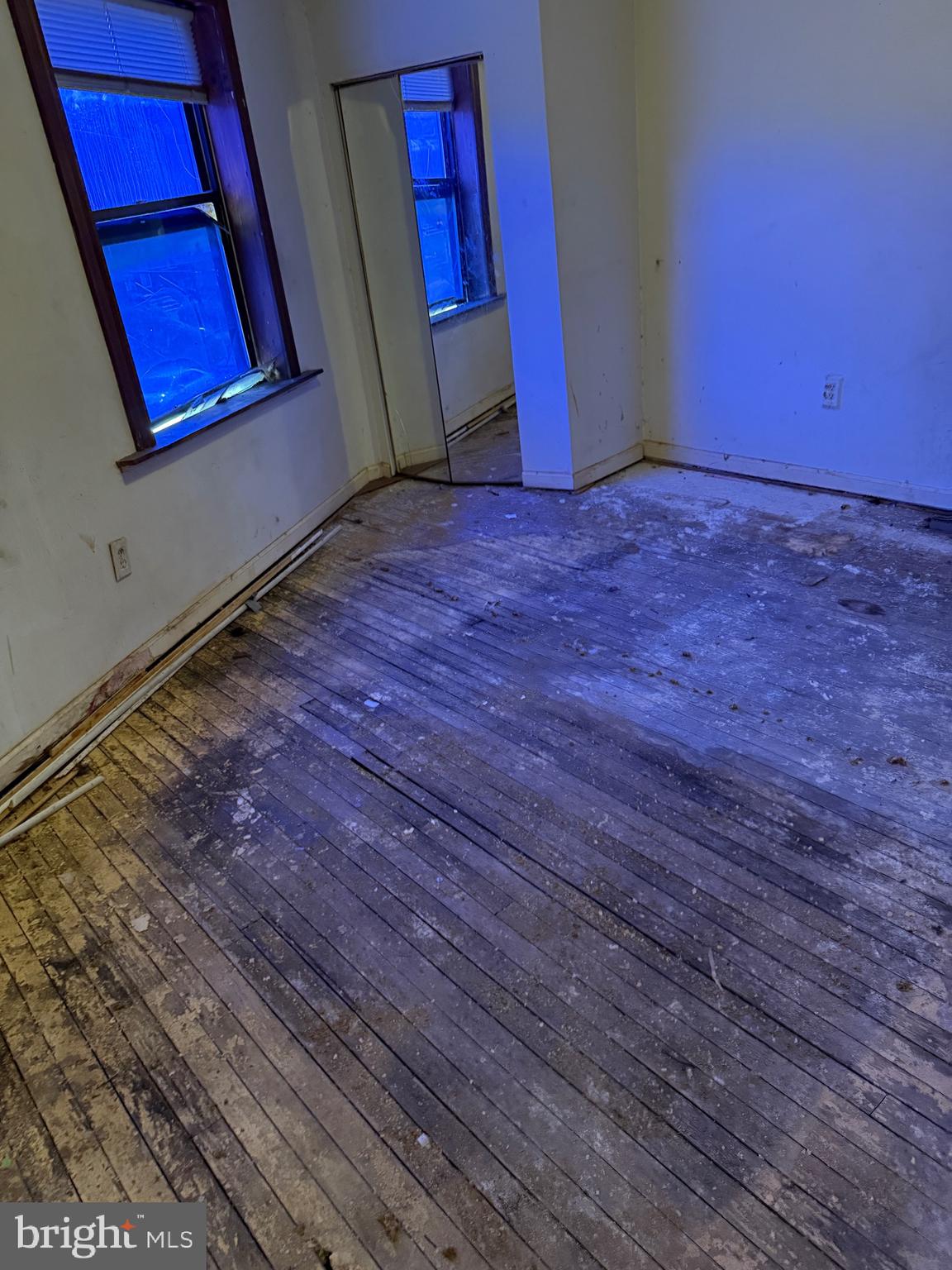 6013 Baltimore Avenue Philadelphia, PA 19143 - Photo 8 of 12 a view of an empty room with wooden floor and window