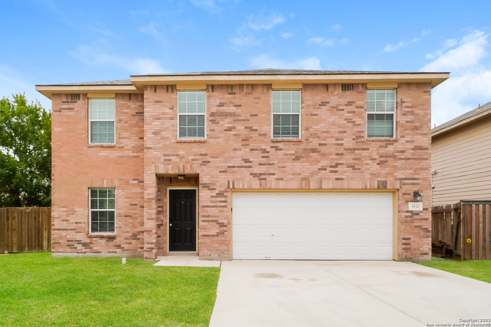 9620 Copper Sands Converse, TX 78109 - Photo 1 of 17 a front view of a house with a garden and yard